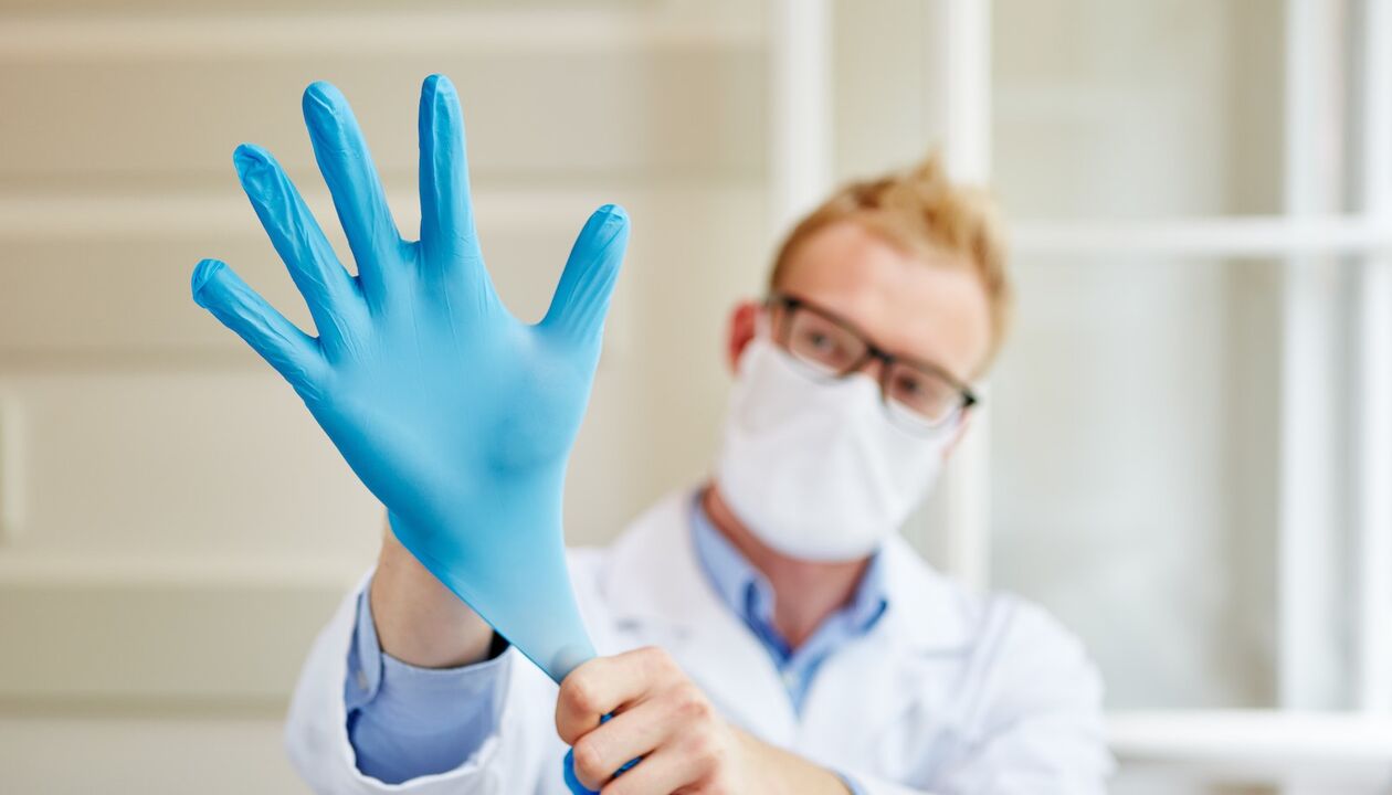 the doctor puts on a glove for massage to prevent prostatitis